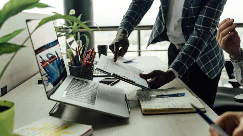 Colleagues collaborating on financial data analysis with a laptop in the office. — The Best Sex Movies for Couples to Watch T