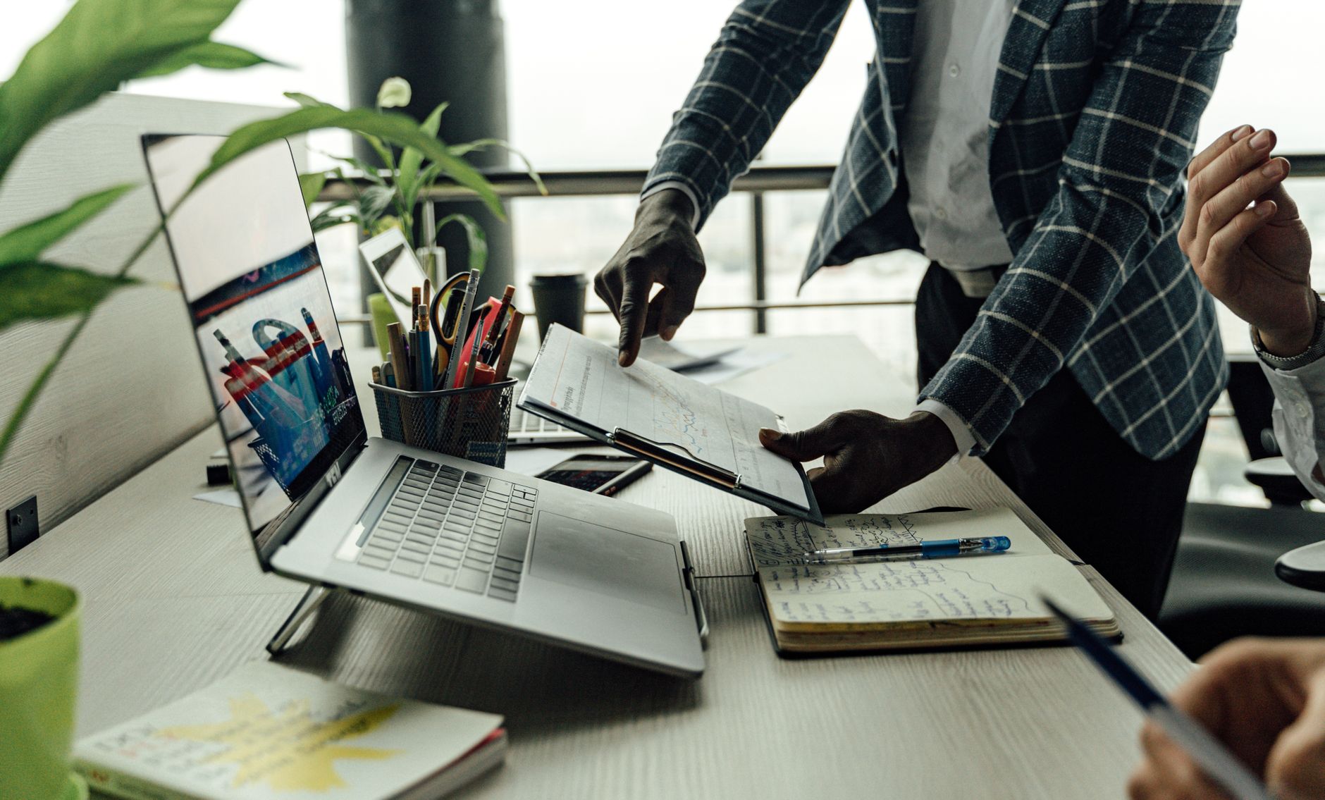 Colleagues collaborating on financial data analysis with a laptop in the office. — The Best Sex Movies for Couples to Watch T
